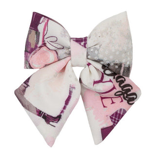 Large decorative hair bow with pink and gray pattern on a white background