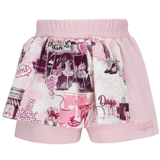 Pink shorts with fashion-themed print on a white background