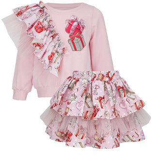 Pink outfit with ruffled top and skirt featuring festive designs on a white background