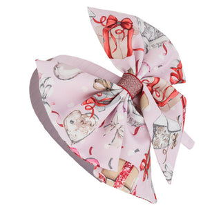 Pink headband by Daga for girls, it has a pink band with a pink bow with presents design on