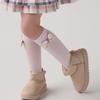 Fluffy Chic by Daga knee high pink cotton socks they have a cream and pink check bow on the side