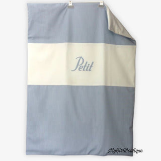 White and blue stripe blanket for boys by Petit Italia it has the petit Italia logo on the front in blue