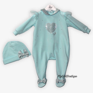 Mint green baby grow for baby girls it has a heart design made out of rhinestones, tulle on the shoulders. It has a silver collar and silver bows on the feet. Matching mint green hat with a silver bow on the front.