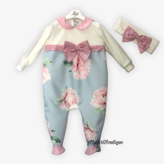 Petit Italia blue and pink satin floral baby grow with a pink bow across the front with dimante petit logo it is matched with a white bow head band