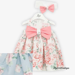 Sleeveless blue dress with pink flowers scattered all over by Petit for girls it has a big bow at the front with a diamanté p on. The matching headband is white with a blue bow