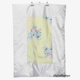 Petit Italia lemon blanket it has blue and pink flower print all over and dimante logo on the bottom corner