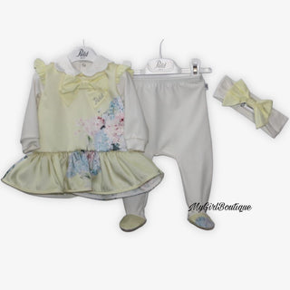 Lemon long sleeve top with pink and blue flower design it has a scalloped white satin collar and a lemon satin bow with the name Petit on the corner of the bow. The white trousers have the lemon floral design on the feet. White headband included with a lemon satin bow on the front