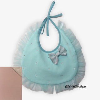 Pink baby’s bib with scattered dimantes all over it has a pink tulle edging and a silver bow on the front