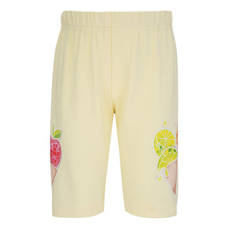 Yellow shorts with fruit designs on a white background