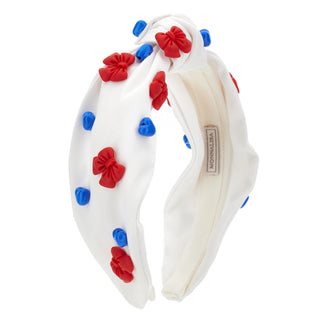 White headband with red and blue bow decorations on a white background